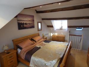 a bedroom with a large bed in a attic at Church Street Cottage in Staithes