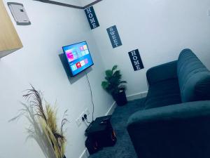 a living room with a couch and a flat screen tv at Salash apartments in Nairobi
