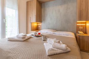 Postel nebo postele na pokoji v ubytování Hotel Luana