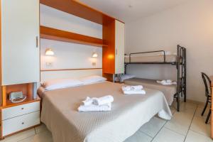 Postel nebo postele na pokoji v ubytování Hotel Luana