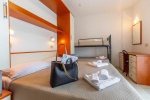 Postel nebo postele na pokoji v ubytování Hotel Luana