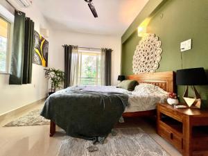 a bedroom with green walls and a bed and a table at The Olive Nest in Verla