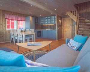 a living room with a couch and a table at Vengsøy Rorbuer in Vengsøya