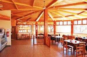 a dining room with tables and chairs in a building at Quechua Hotel in San Pedro de Atacama