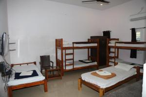 a room with several bunk beds in a room at Blissful Haven Art House - near entrance to Auroville in Auroville