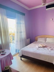 a bedroom with purple walls and a bed with a dog laying on it at Villa Jakos Paradise in Batumi