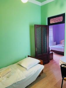 a bedroom with a bed and a room with a door at Villa Jakos Paradise in Batumi