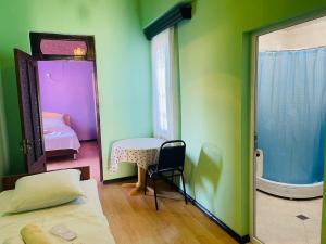 a room with a bed and a table and a mirror at Villa Jakos Paradise in Batumi