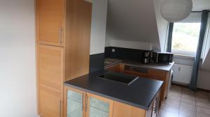a kitchen with a black counter top and a sink at Apartment Hersbruck 4 ROOMS Ausblick WLAN Zentral und Natur in Hersbruck