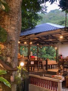 a patio with a restaurant with a table at Chomklong Experience in Pak Chong