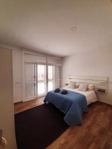 a bedroom with a bed and a large window at Costa Teguise II in Teguise