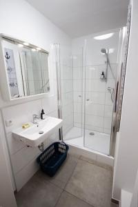 a white bathroom with a sink and a shower at Fabrikdesign Düren in Düren - Eifel