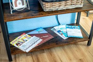 a wooden table with pamphlets and magazines on it at Fabrikdesign Düren in Düren - Eifel