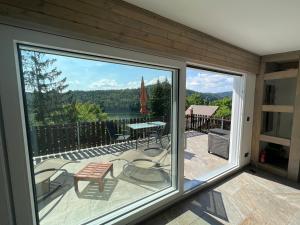 a screened in porch with a view of a lake at Saale-Residenz in Unterwellenborn