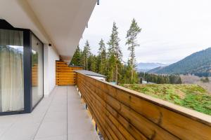 a balcony with a view of the mountains at Spa & Wellness Hotel Fitak**** in Liptovský Ján