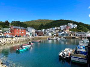 a group of boats are docked in a harbor at A do Caseiro in O Barqueiro