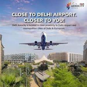an airplane is flying in the sky over a city at Hotel Aerocity Golden Near IgI New Delhi Airport in New Delhi