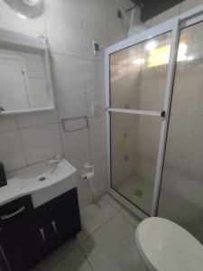 a bathroom with a shower and a toilet and a sink at Cabaña Las Palmeras in El Soberbio