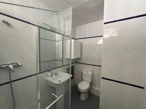 a bathroom with a toilet and a sink at Tamarindo 5 in Benalmádena