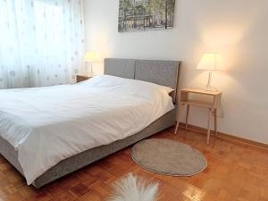 um quarto com uma cama e duas mesas com candeeiros em Novobeogradska priča em Belgrado