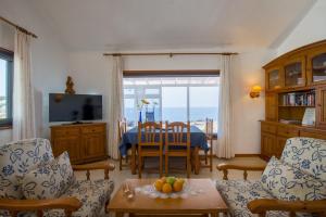 a living room with a view of the ocean at Casa Salida del Sol in Charco del Palo