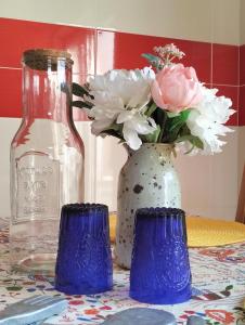 a vase with flowers in it sitting on a table at VILLA ANDORINHA with Private Pool in a quiet area in Aljezur