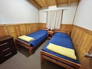 Cama o camas de una habitación en Cabañas El Boldo