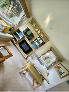 an overhead view of a living room with a chair at Janet's Beautiful Country Caravan in Pwllheli