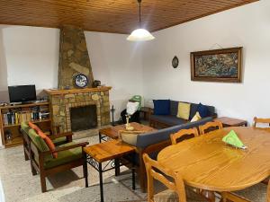 a living room with a table and a fireplace at Omodos Village Houses in Omodos