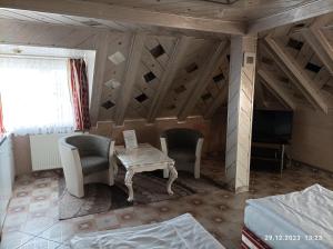 a room with a fireplace and two chairs and a table at Central Hotel in Schwetzingen +78 photos