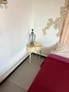 a room with a bed and a table with a lamp at K.tripla in San Giorgio