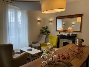 a living room with a wooden table and chairs at Le St Vincent in Roquefort