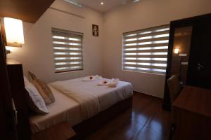 a bedroom with a bed with two dolls on it at Cloud 9 Homestay, Thekkady in Thekkady
