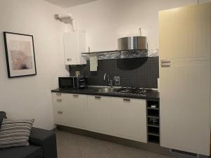 a kitchen with a sink and a stove top oven at Cuore di Parma in Parma