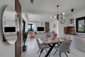 a dining room and living room with a table and chairs at Villa Bomada in Tučepi