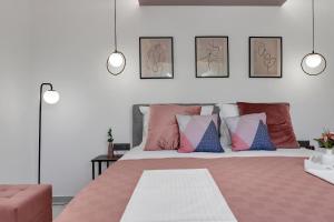 a bedroom with a large bed with colorful pillows at Villa Bomada in Tučepi