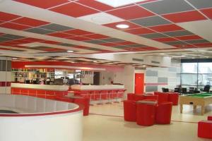 a library with red chairs and ping pong tables at location maison vacance in Pouru-Saint-Rémy