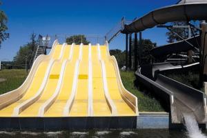 a slide in a park with a water slide at location maison vacance in Pouru-Saint-Rémy
