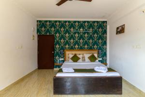 Ένα ή περισσότερα κρεβάτια σε δωμάτιο στο De Alara Calangute