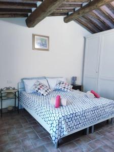 a bedroom with a bed with pillows on it at Gest Short Rent Siena 2 in Siena +24 photos