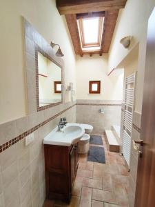 a bathroom with a sink and a toilet and a window at Gest Short Rent Siena 2 in Siena