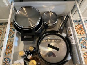 a group of four pots and pans on a stove at Suite Lady Marian in Roccaraso