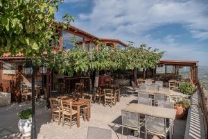 a restaurant with tables and chairs in front of a building at Earino in Kato Asites