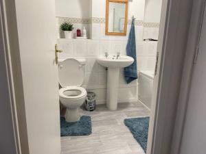 a bathroom with a toilet and a sink at Barleyfields. Entire House 4 beds 2 baths in Audley