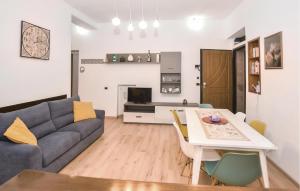 a living room with a couch and a table at Awesome Apartment In Tuscania With Kitchenette in Tuscania