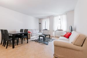 a living room with a couch and a table at Sartori Mountain Apartment in Pinzolo