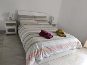 1 dormitorio con 1 cama con 2 toallas en Chalet junto al mar con jardín privado, en La Cala de Mijas