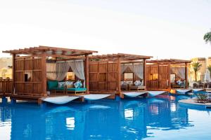 a group of tents on the water in a resort at Rixos Sharm El Sheikh - Ultra All Inclusive Adults Only 18 Plus in Sharm El Sheikh