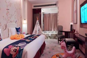 a bedroom with a large bed and a room with a table at Ramada Plaza Qiandeng Kunshan in Kunshan