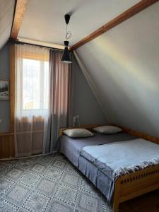 ヤレムチャにあるSadyba Girske Povitriaのベッドルーム1室(ベッド1台付)、窓が備わります。